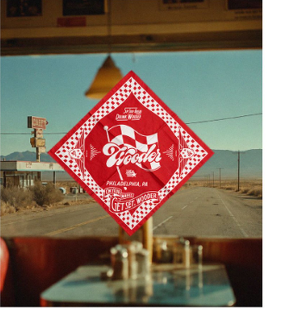 Wooder bandana hanging in a diner window looking out on an open desert road