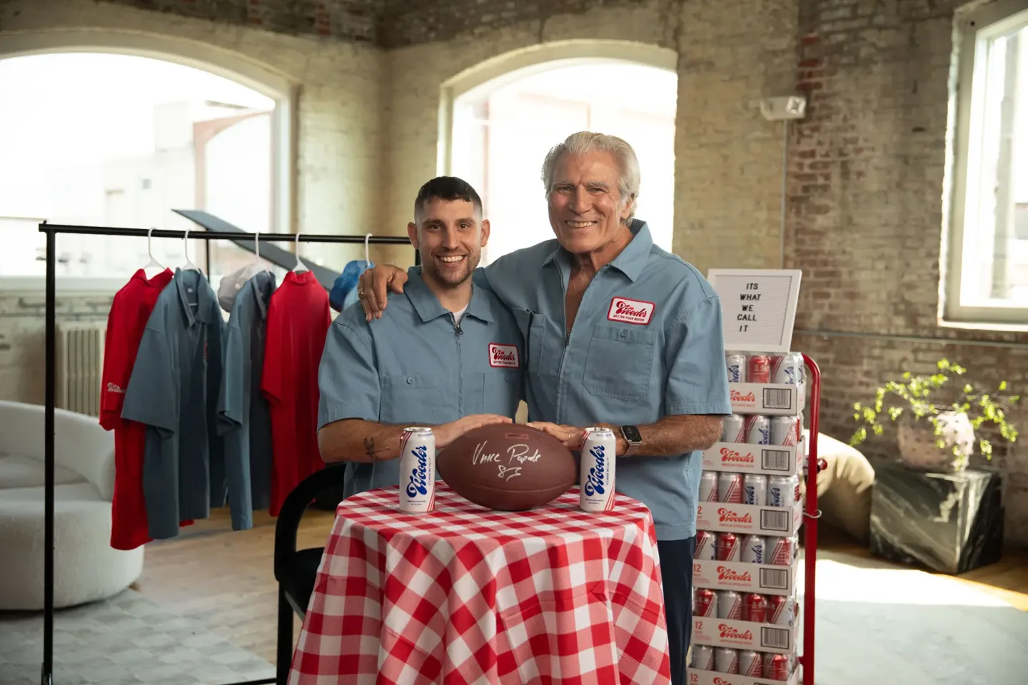 Vince Papale and the Wooder team with cans of Wooder water and a signed football